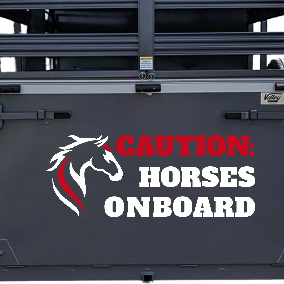 Caution horses onboard red and white sticker on grey horse trailer